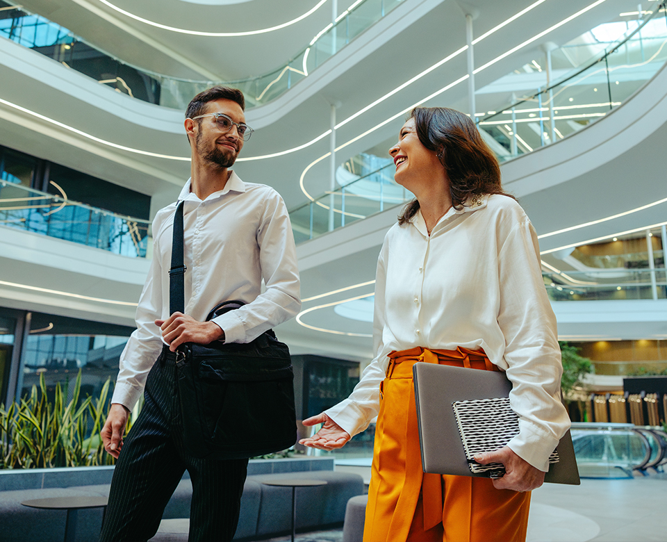 Colleagues walking through modern office
