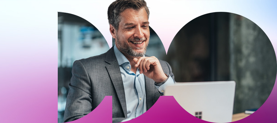 Man smiling while working on laptop