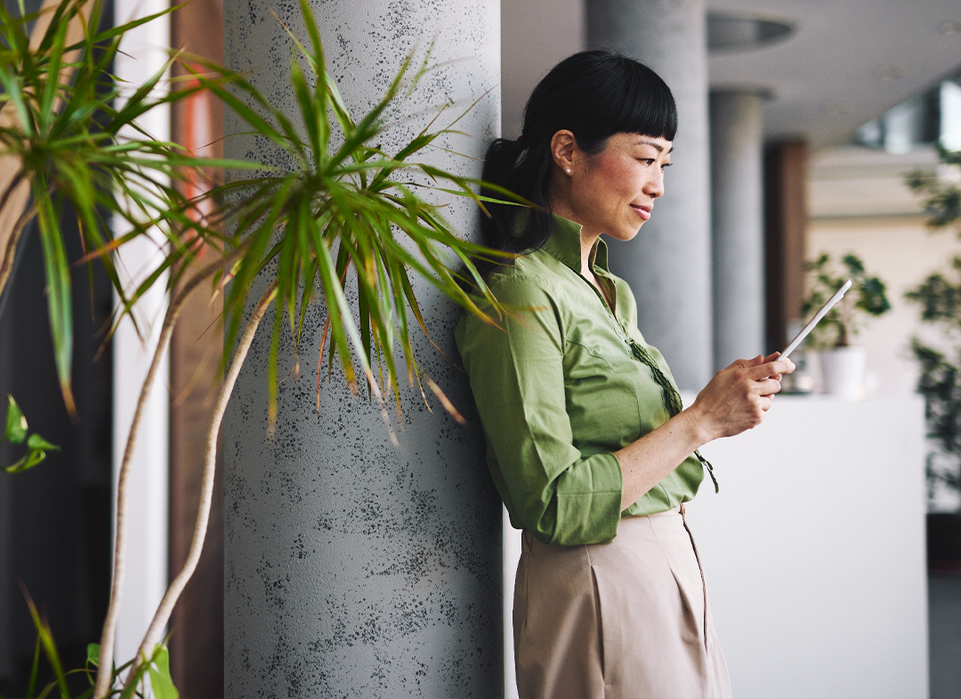 Woman smiling while working on a tablet