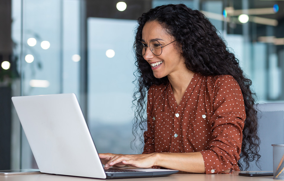 Smiling woman working on laptop