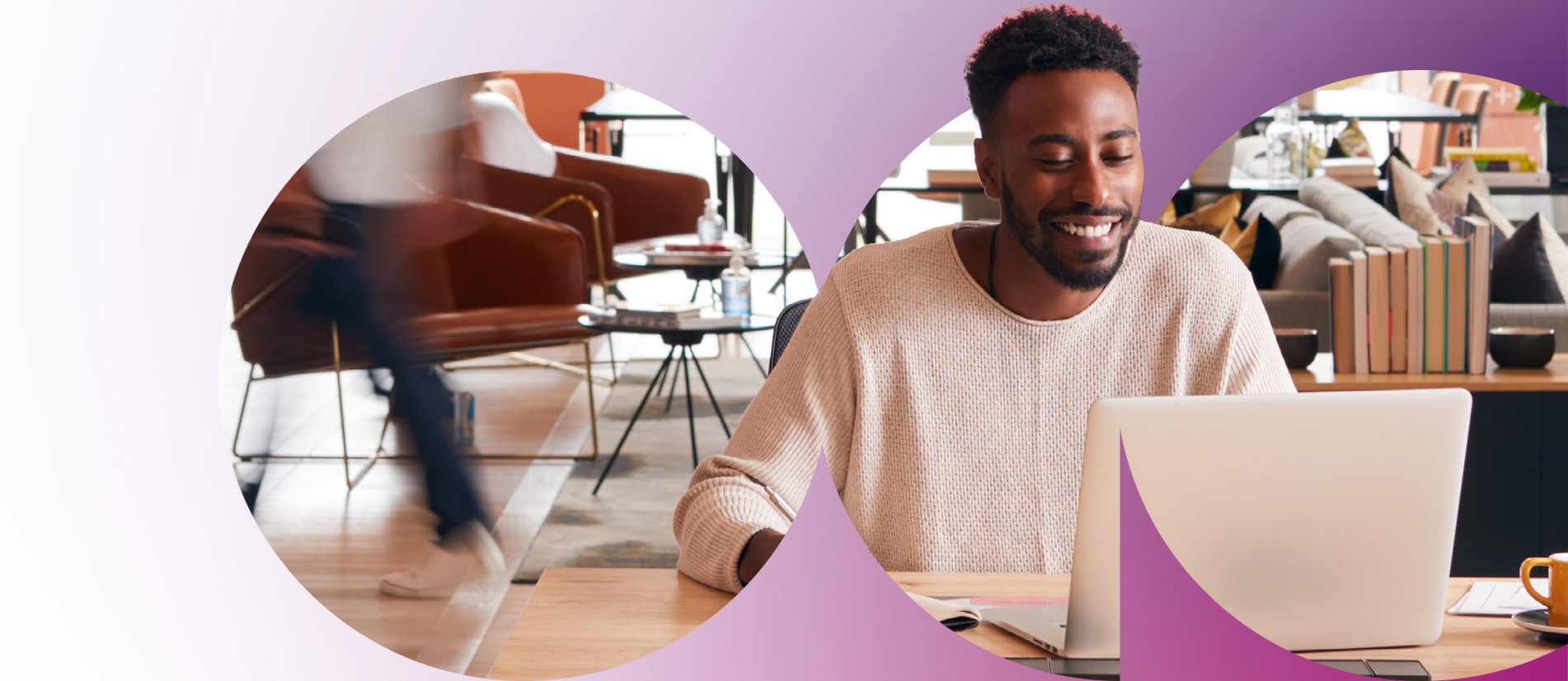 Man smiling while working on laptop