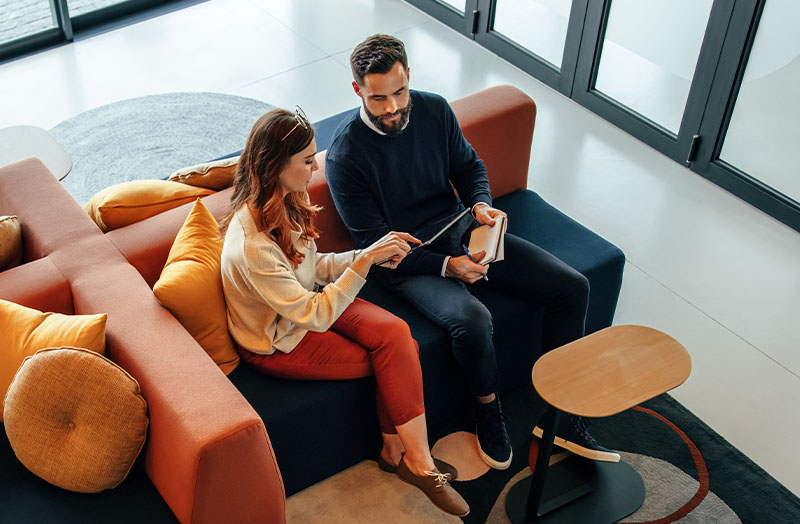 Two colleagues during a meeting in a break-out area