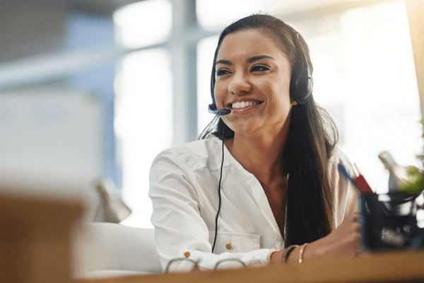 Smiling call center representative taking calls