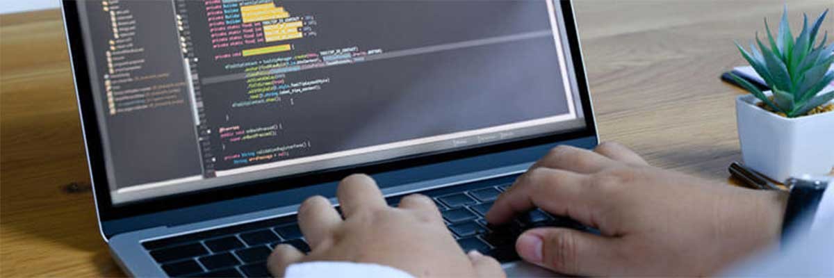 A Java programmer behind his laptop