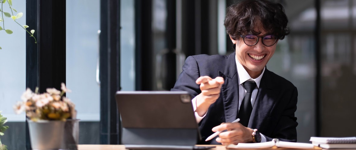 The new M365 Continual Adoption Solution Man in a suit smiling on a video call