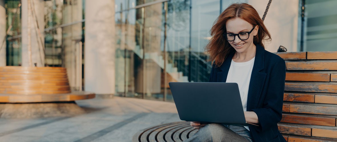 Smartly dressed woman working on a laptop