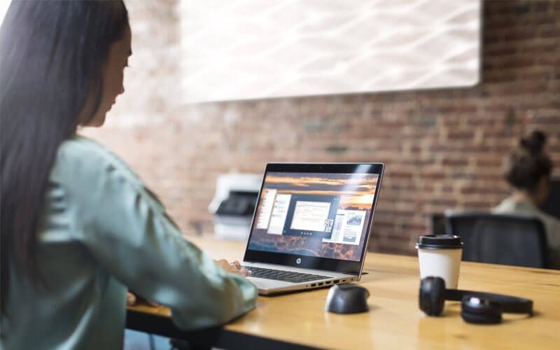 Een jonge vrouw werkt op een HP ProBook notebook