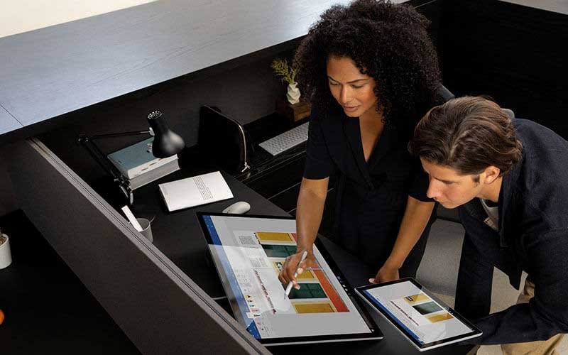 Colleagues using a Surface Studio 2